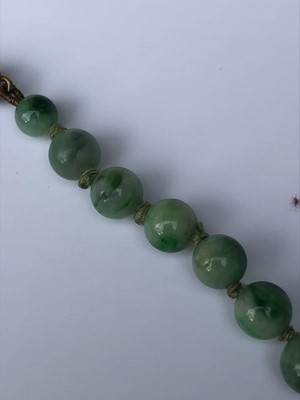 Lot 220 - A Chinese jade necklace, with graduated beads,...