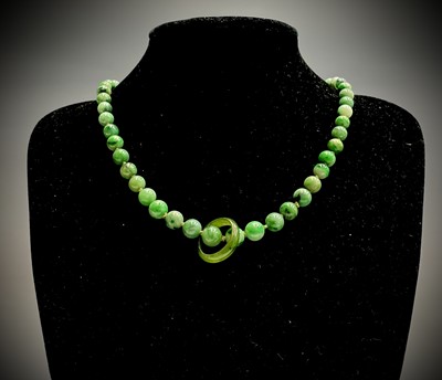 Lot 220 - A Chinese jade necklace, with graduated beads,...