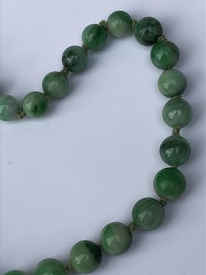 Lot 220 - A Chinese jade necklace, with graduated beads,...