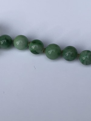 Lot 220 - A Chinese jade necklace, with graduated beads,...