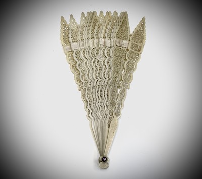 Lot 217 - A Chinese pierced ivory fan, circa 1900,...