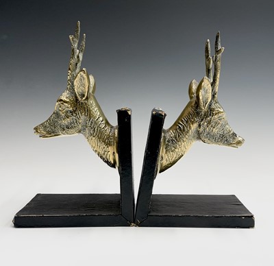 Lot 457 - A pair of brass bookends, 1920s, mounted with...