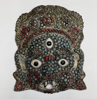 Lot 219 - A Tibetan archaistic bronze face mask of...