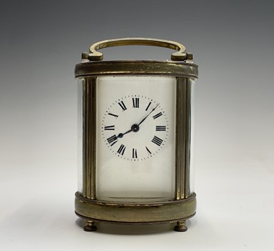 Lot 2936 - A French oval brass cased carriage timepiece,...