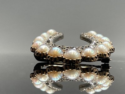 Lot 351 - A Victorian diamond and pearl horseshoe brooch...