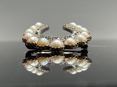 Lot 351 - A Victorian diamond and pearl horseshoe brooch...