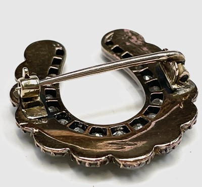 Lot 351 - A Victorian diamond and pearl horseshoe brooch...