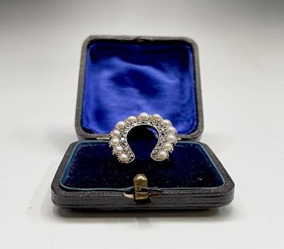 Lot 351 - A Victorian diamond and pearl horseshoe brooch...