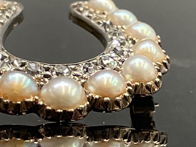 Lot 351 - A Victorian diamond and pearl horseshoe brooch...