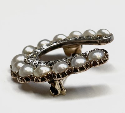 Lot 351 - A Victorian diamond and pearl horseshoe brooch...