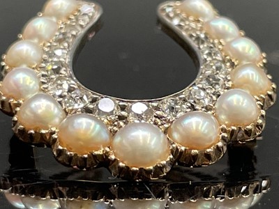 Lot 351 - A Victorian diamond and pearl horseshoe brooch...