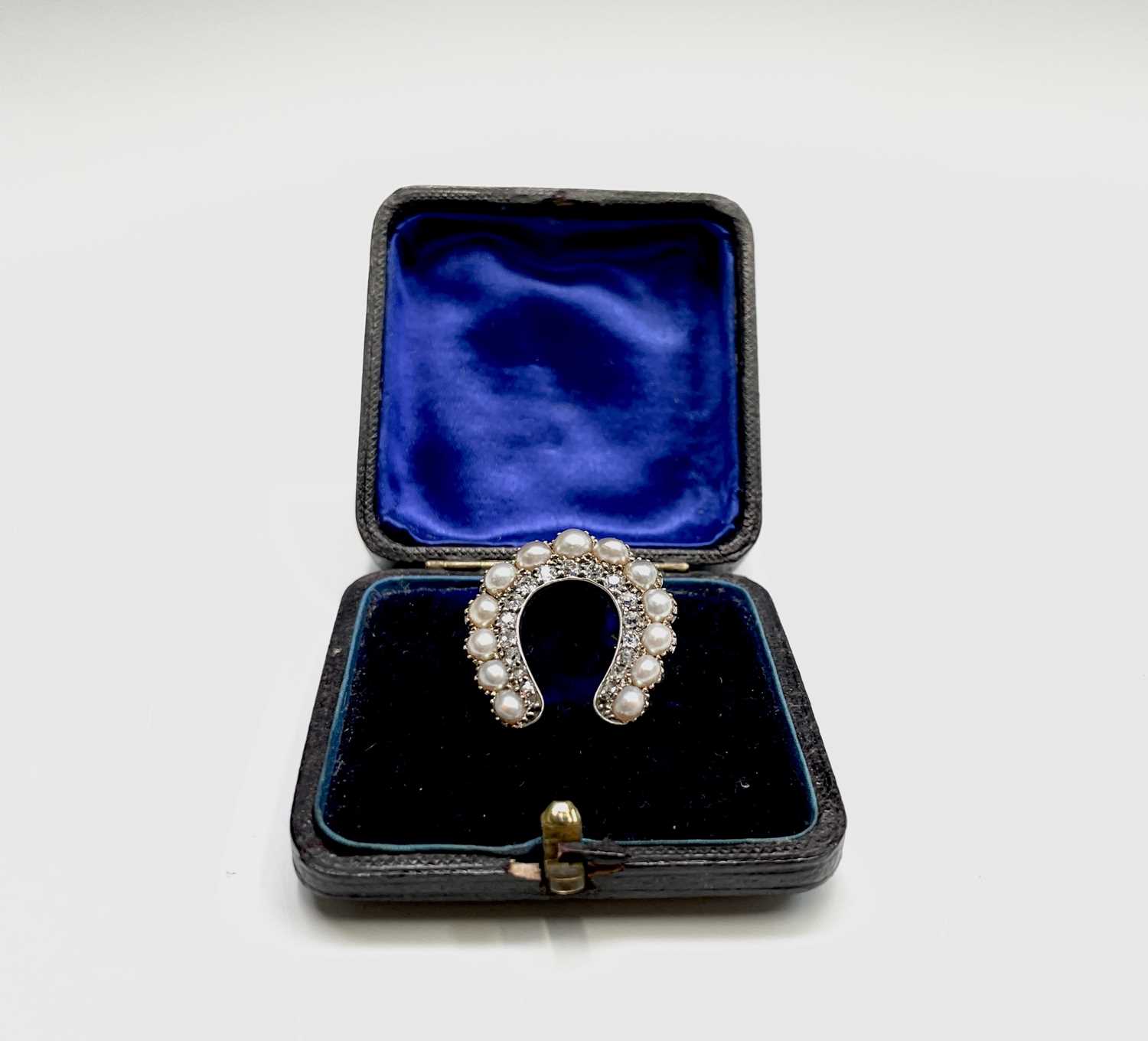 Lot 351 - A Victorian diamond and pearl horseshoe brooch...
