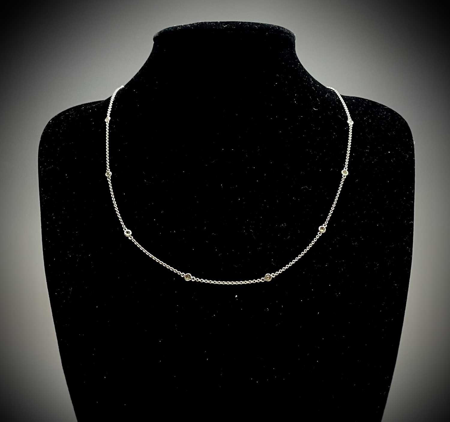 Lot 321 - An 18ct white gold 48cm chain spaced with 12