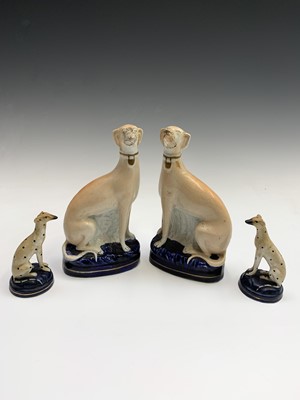 Lot 812 - A pair of Staffordshire seated figures of...