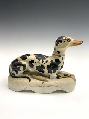 Lot 813 - A Staffordshire figure of a recumbent black...