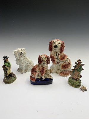 Lot 814 - A Staffordshire figure of a seated spaniel and...