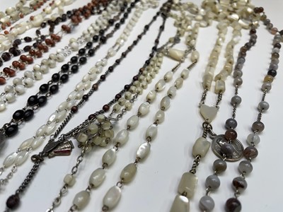 Lot 430 - Fourteen rosary bead necklaces, all with...