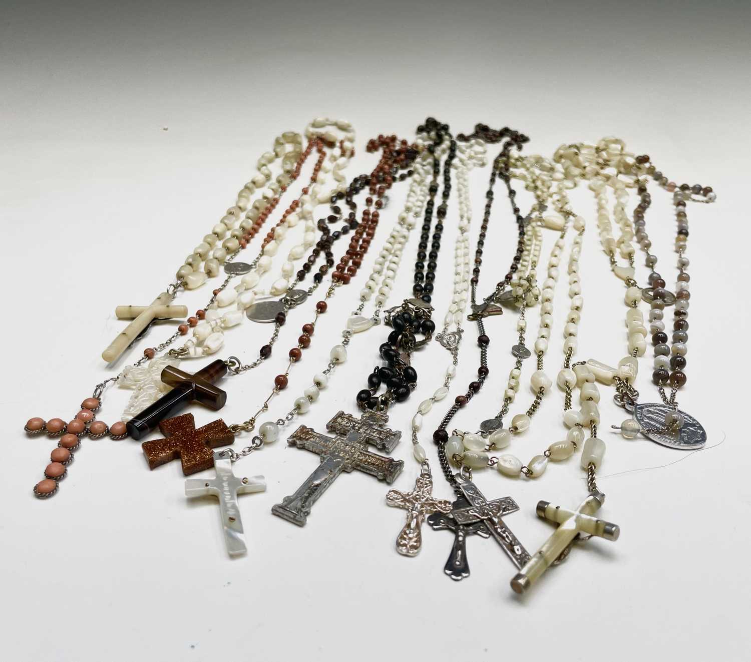 Lot 430 - Fourteen rosary bead necklaces, all with...