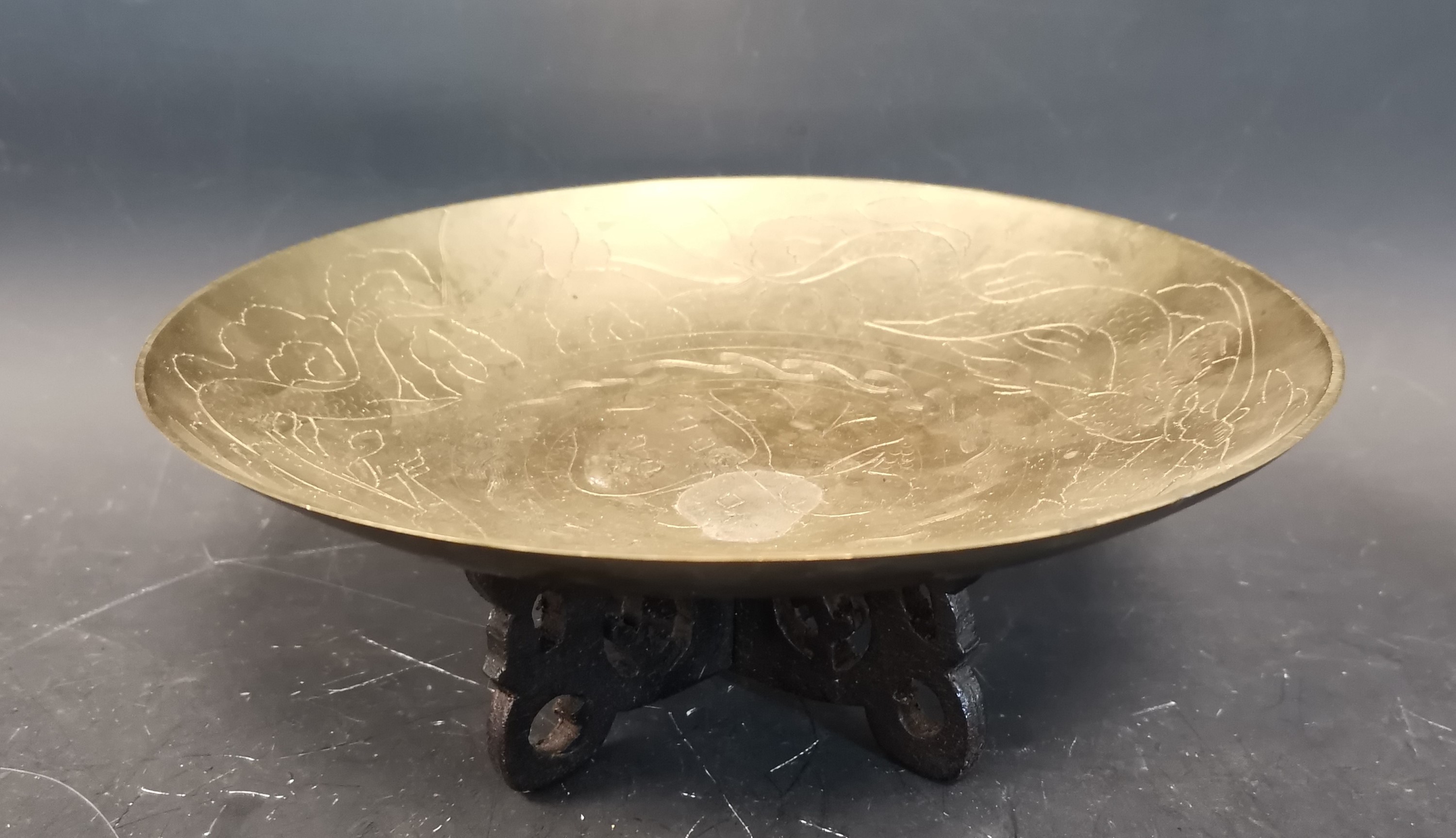A Chinese brass bowl with engraved decoration...