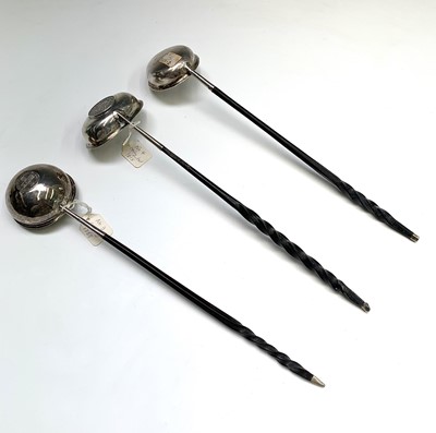 Lot 73 - Three silver punch ladles with unadorned bowls...