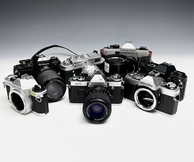 Lot 302 - Seven SLR cameras, A Nikon EM, a Fujica AX-5,...