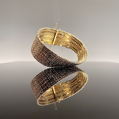 Lot 271 - A 14ct woven yellow gold bracelet 22mm wide...