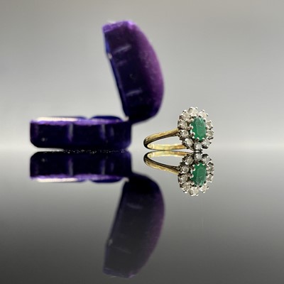 An 18ct yellow gold oval diamond and emerald...