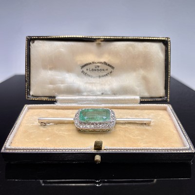 An Art Deco platinum brooch set a 6ct emerald...