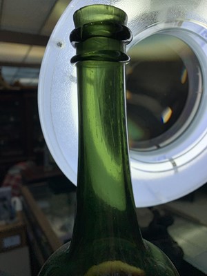 Lot 56 - A late 18th century blown green glass bottle....