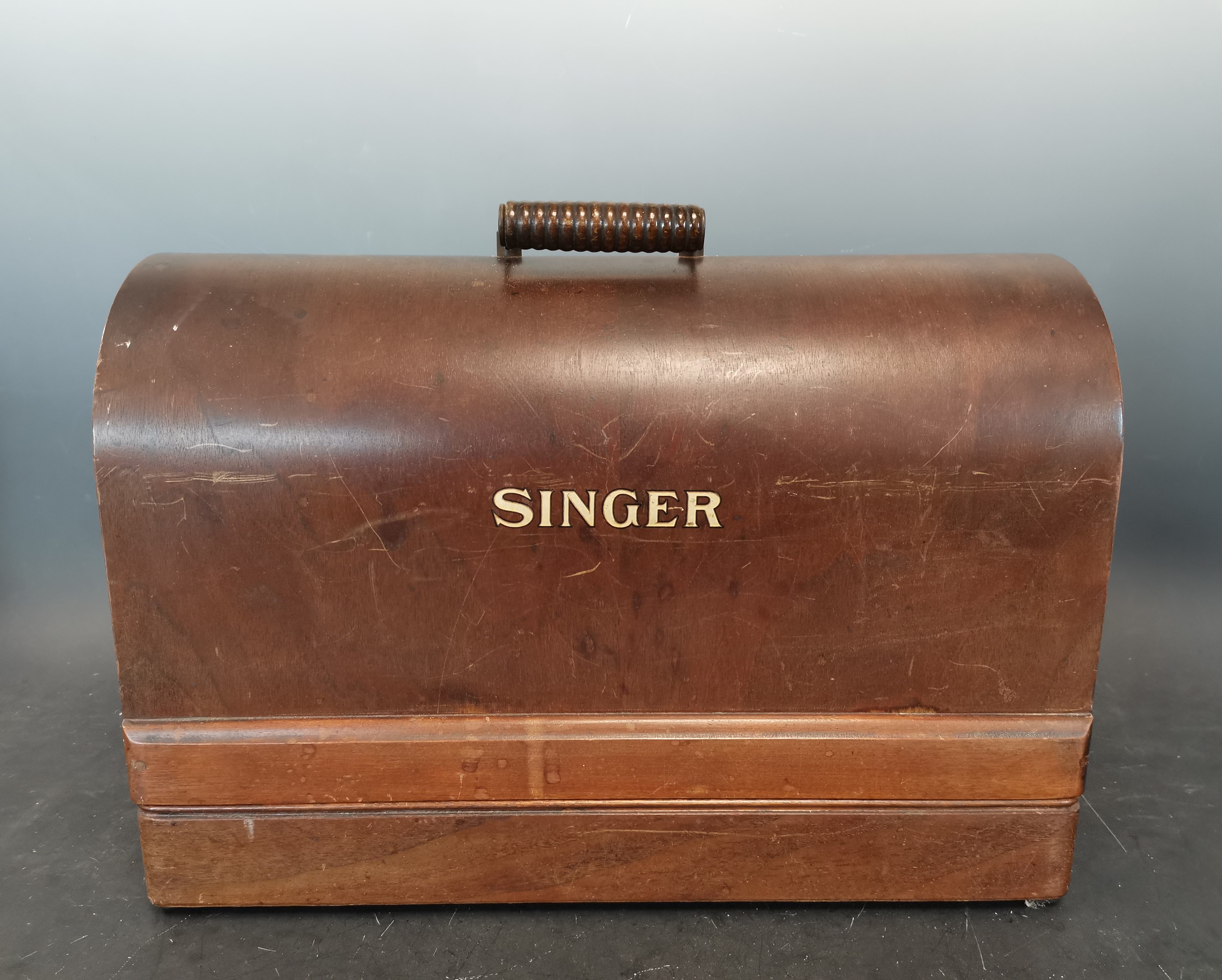 Lot 137 A 1930s Singer sewing machine with wooden
