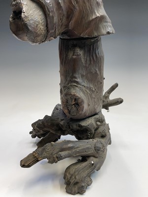 Lot 114 - A Chinese carved rootwood figure of a man in a...