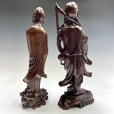 Lot 121 - Two Chinese carved wood figures, 19th century,...