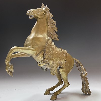 Lot 79 - A pair of brass rearing horse ornaments in the...