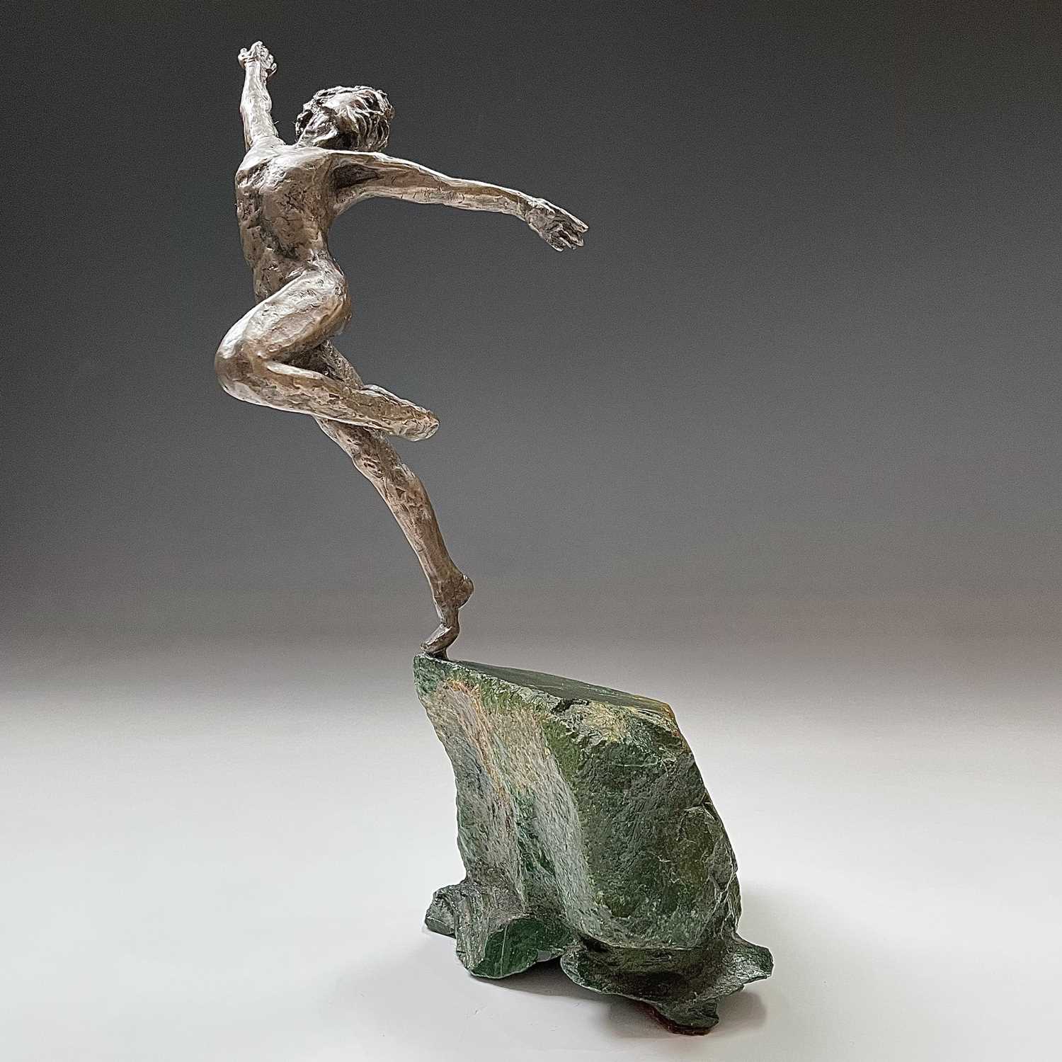 Lot 83 - A bronzed figure of a dancing male, on green...