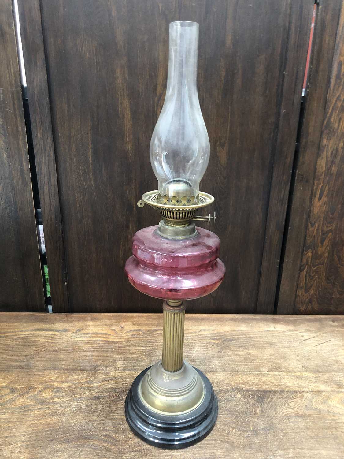 Lot 18 - A Victorian cranberry glass oil lamp, height...