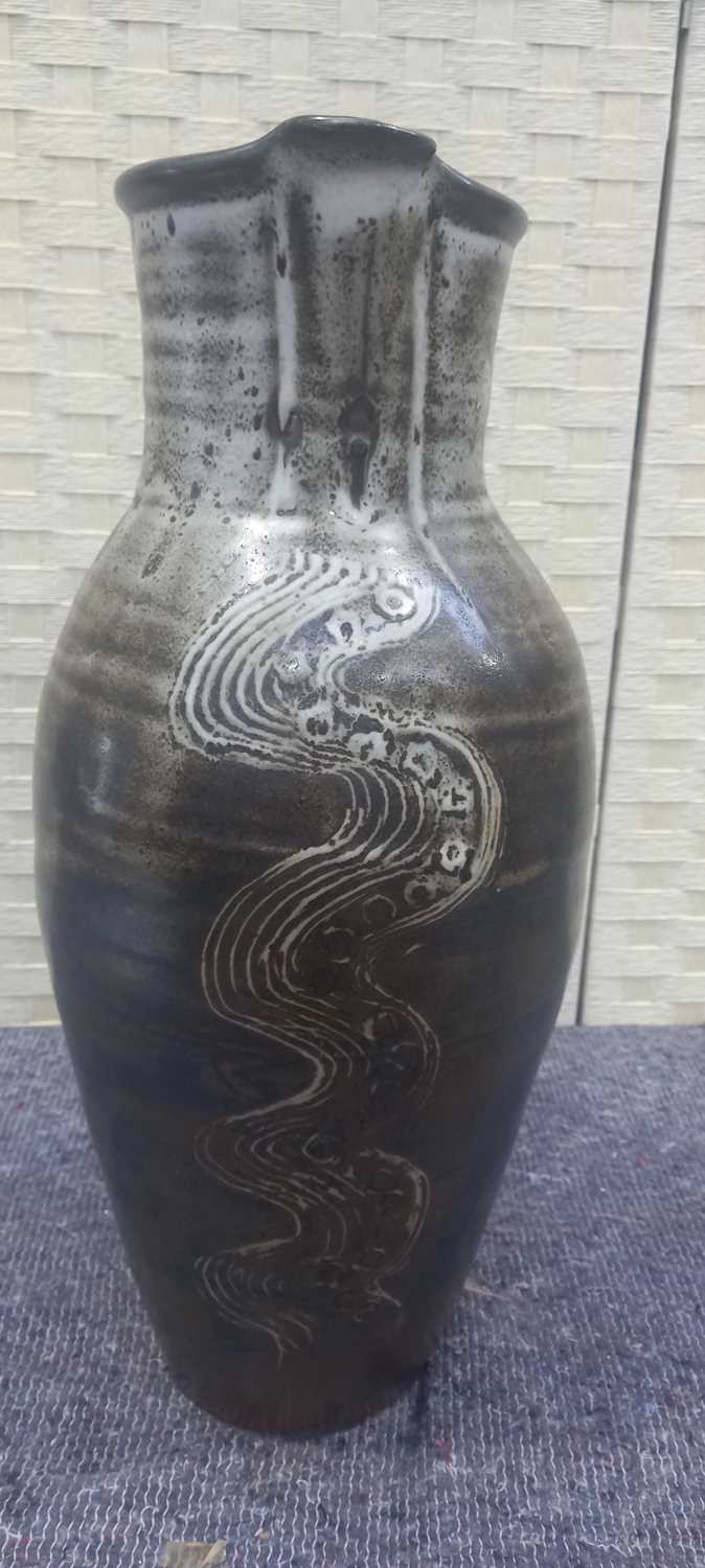 Lot 5 - A tall studio pottery jug with scraffito wave...