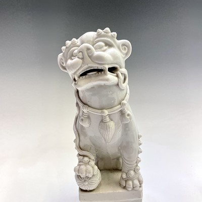 Lot 38 - A Chinese blanc de chine model of a dog of fo,...