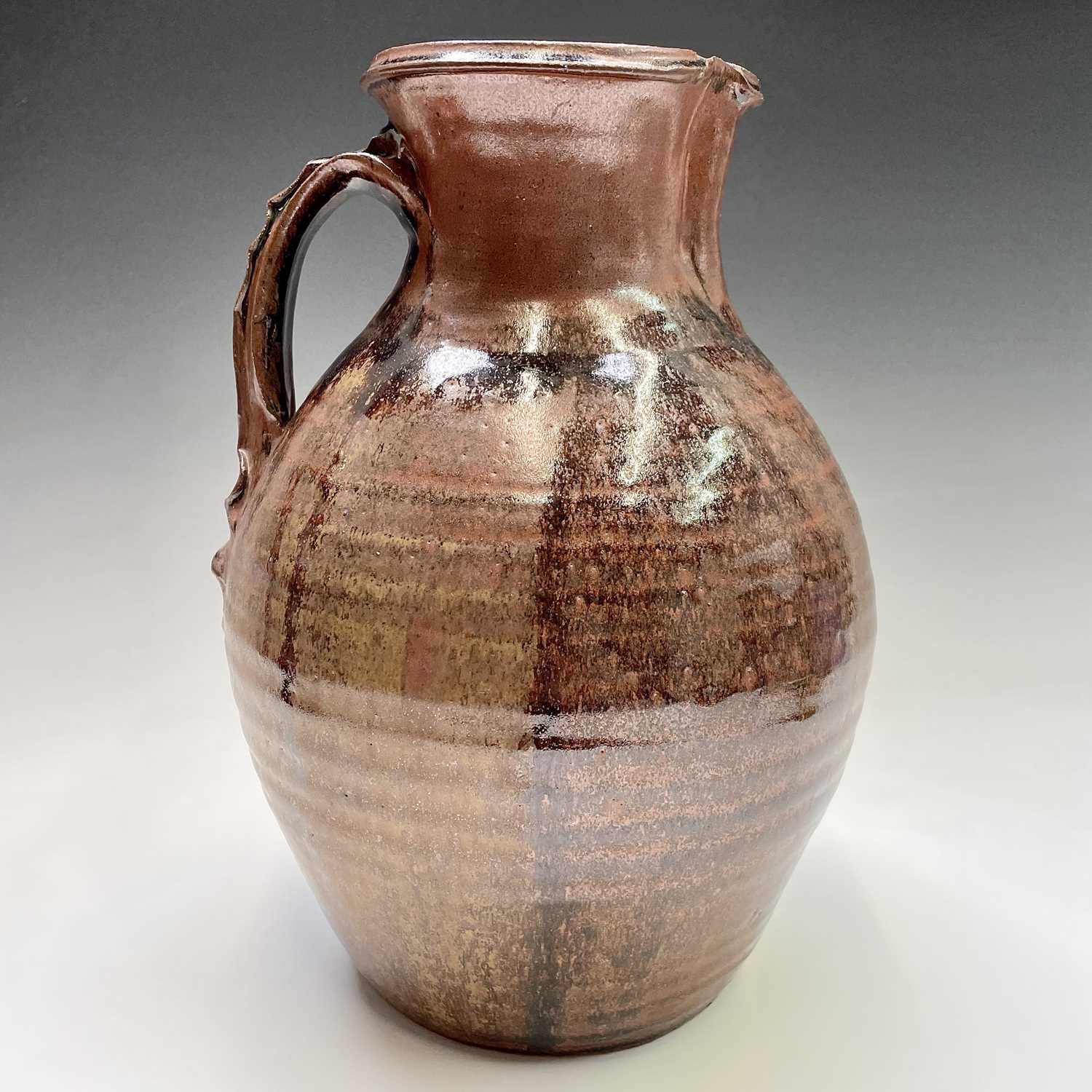 Lot 920 - A large studio pottery brown glazed jug,...