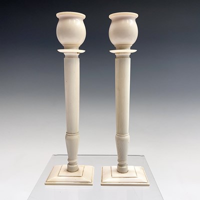 Lot 1006 - A pair of Anglo-Indian ivory candlesticks,...