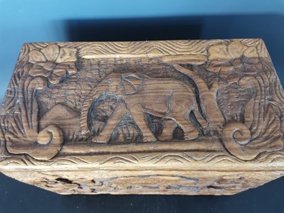 Lot 20 - A decoratively hand carved African wooden box...