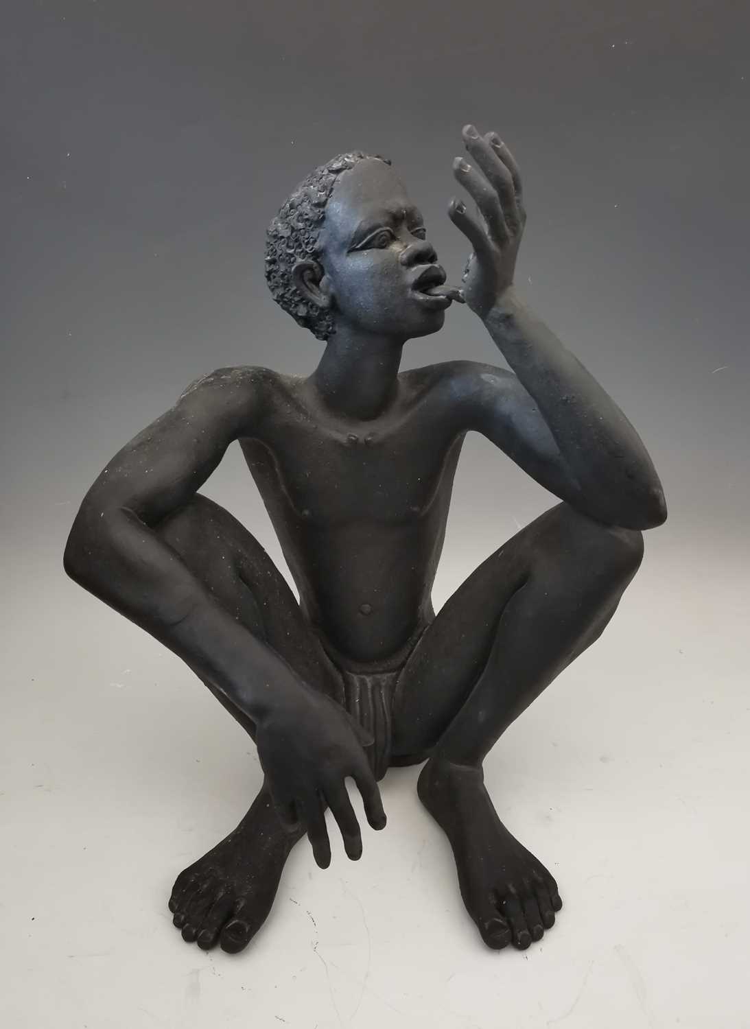 Lot 11 - A large fired clay figurine of a boy,...