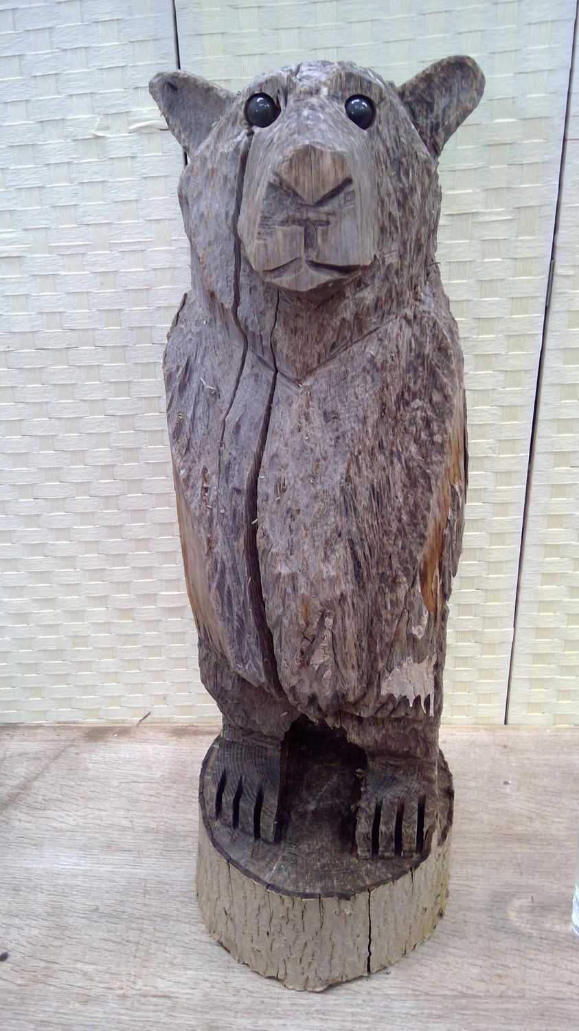 Lot 6 - A hand-carved wooden bear statue from one...