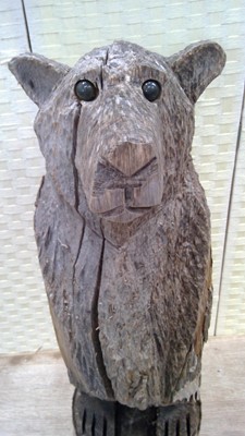 Lot 6 - A hand-carved wooden bear statue from one...