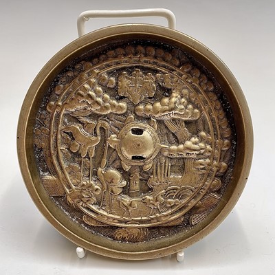 Lot 161 - A Japanese bronze mirror, decorated with...