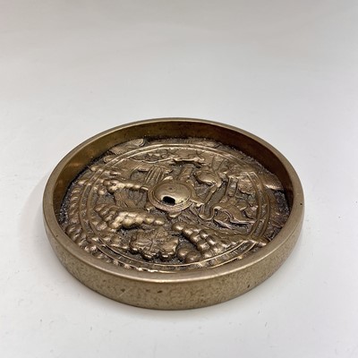 Lot 161 - A Japanese bronze mirror, decorated with...