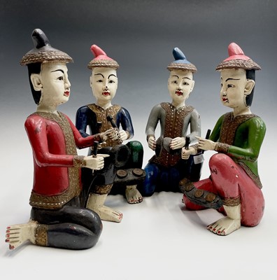 Lot 93 - A set of four South East Asian painted wood...