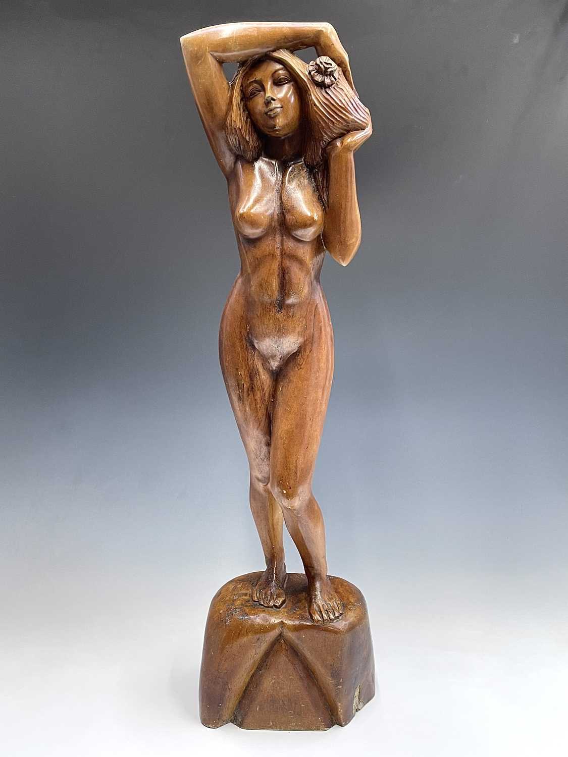 Lot 229 - A carved wooden figure of a standing female...