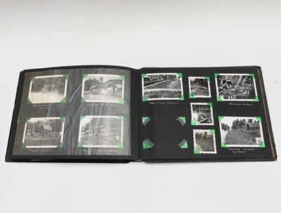 Lot 30 - A black Japanned photograph album depicting...