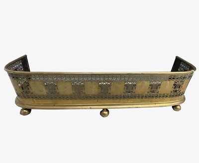 Lot 111 - An early Victorian brass fender, pierced with...