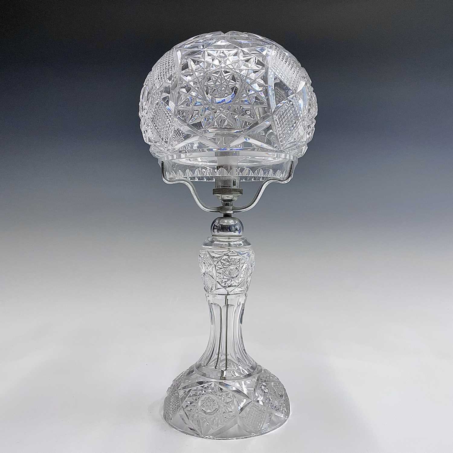 Lot 943 - A cut glass table lamp and shade, with hobnail...